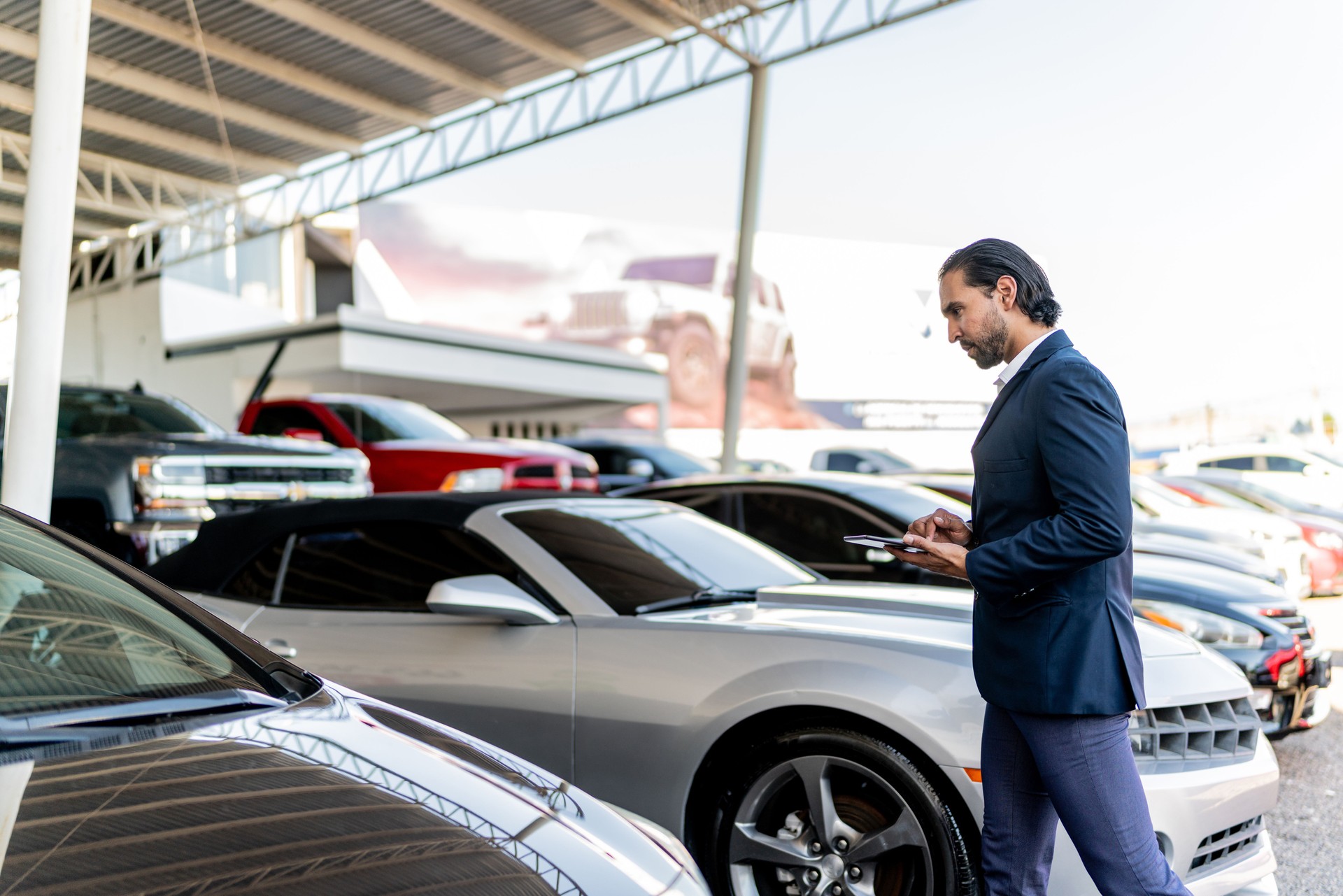 Car salesman checking the dealership showroom